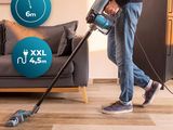 the man is cleaning the floor with a vacuum cleaner