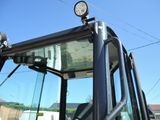 a close up of the front of a truck with the lights on