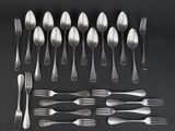a lot of silver spoons and forks on the table