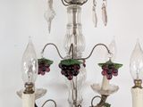 a chandelier that has grapes on the top of it