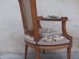 a wooden chair with a floral upholstered seat