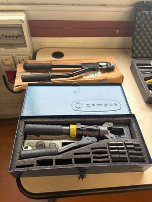 two tools in a case on a table next to a window