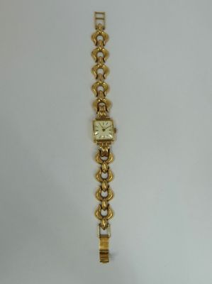 a close up of a wrist watch on a white surface