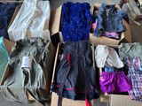 a box full of clothes that is sitting on the floor