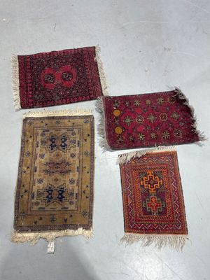 four oriental rugs are laid out on the floor