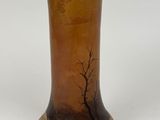 a brown vase with a tree on it sitting on a table