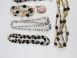 a lot of jewelry that is laying out on the table