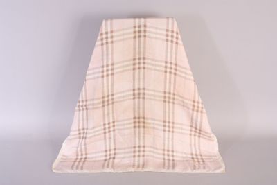 beige and brown checkered blanket on a white surface