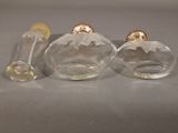three glass vases sitting next to each other on a table