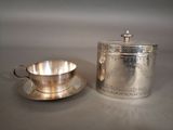 silver plated tea set with a cup and saucer on a saucer
