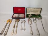 a lot of silverware in a case on a table