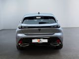 the rear end of a silver car in a white room