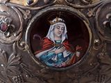 a silver vase with a picture of a woman on it