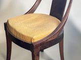 an image of a wooden chair with a yellow cushion on it