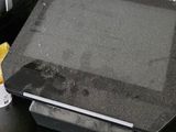 a black table with a laptop and other electronics on it