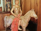 a statue of a woman riding a horse in a room