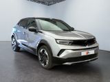 the silver suv is parked in a white room with a black floor