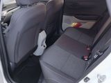 the back seats of a white car with a black seat belt