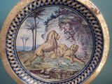 a plate with a picture of a lion and a dog on it