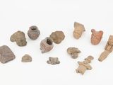 several pieces of pottery are displayed on a white surface
