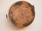 a brown and black pot on a white table