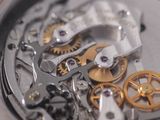 a close up view of a watch with gears on it