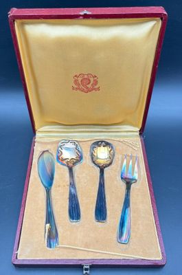 four spoons and a fork in a case