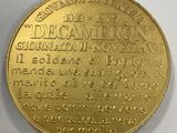 a close up of a gold coin on a white surface