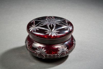 a red glass box with a flower design on it