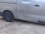 a silver van that is parked on the side of the road