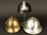 three different types of helmets sitting on top of a black surface