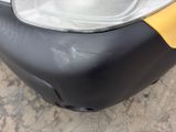 a close up of a black and yellow suitcase on the ground