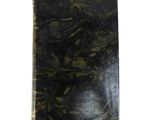 a black book with green leaves on it on a white surface