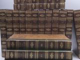 several books stacked on top of each other on a white surface