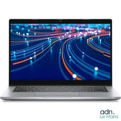 the laptop is open on a white background with a blurry background