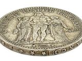 a close up of a coin on a white surface