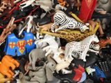 a pile of toy animals that are on a table