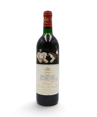 bottle of red wine with corks on a white background