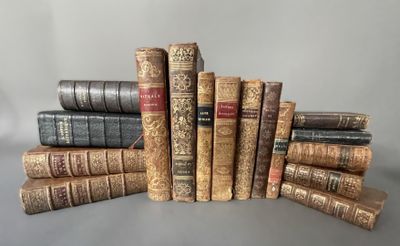 several old books stacked on top of each other on a table