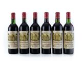 six bottles of red wine lined up in a row
