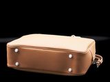 beige leather case with rivets and rivets on a black background