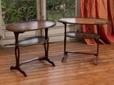 two tables sitting on a wooden floor in front of a window