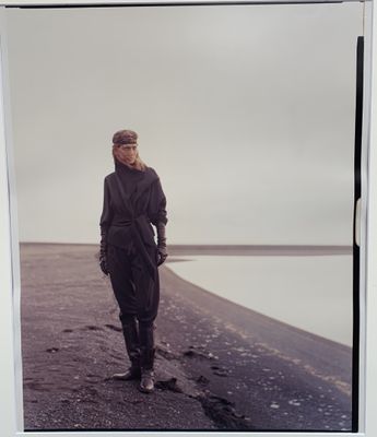une photo en noir et blanc d'un homme debout sur une plage