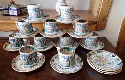 a lot of cups and saucers on the table