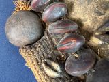 a close up of a necklace with stones on it
