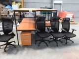 a lot of office chairs and a desk in a warehouse