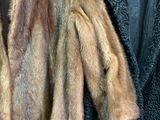 a fur coat hanging on a hanger in a room