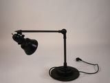 a black lamp that is on a white table