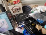 a pile of assorted electronics and other items on the floor