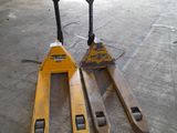 two forklifts that are sitting in a warehouse